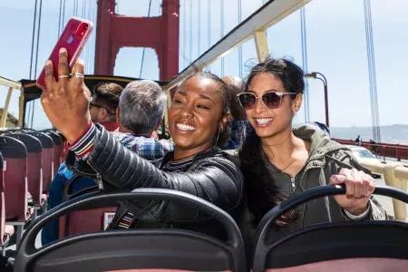 Friends taking selfies on the Golden Gate Bridge